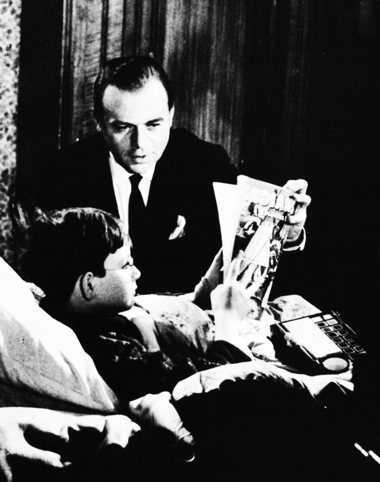 Herbert Lom talks to a boy in bed