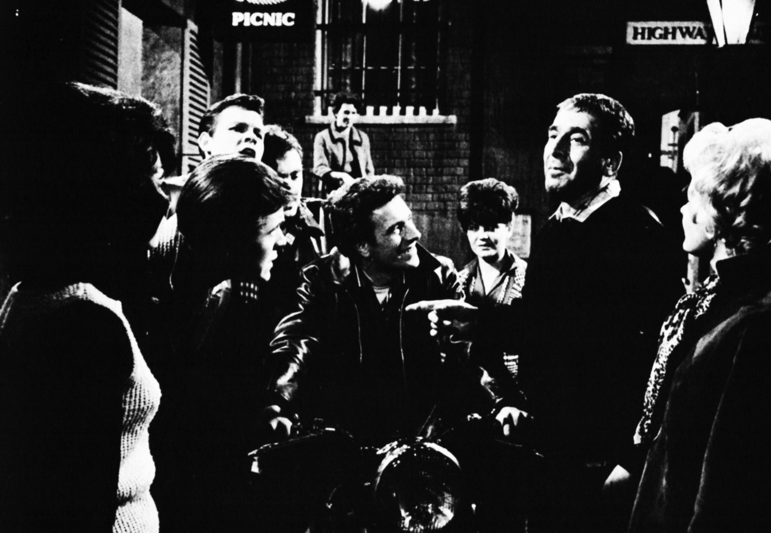 Teenagers and Leonard Sachs in a back alley